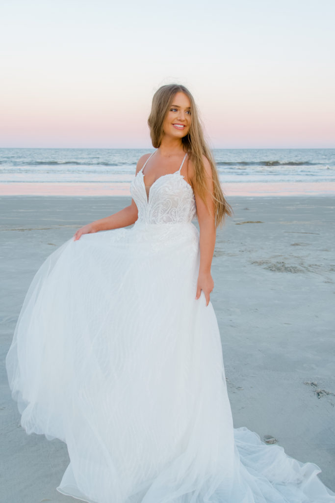 beaded lace and tulle aline wedding dress on beach at sunrise