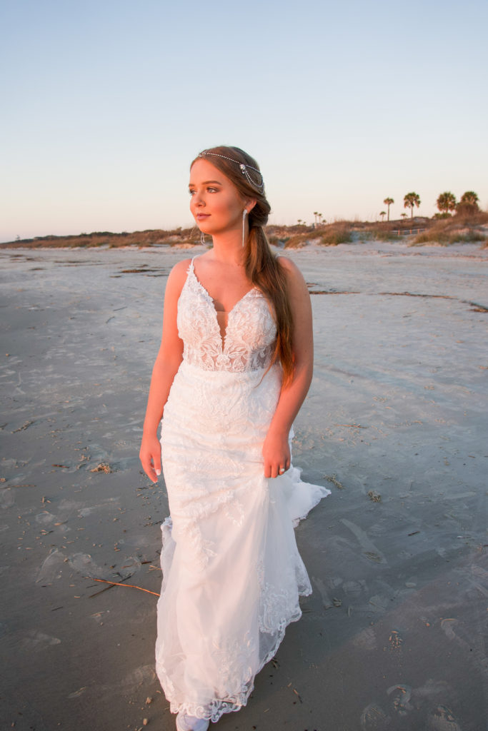 lace fitted wedding dress on beach at sunrise