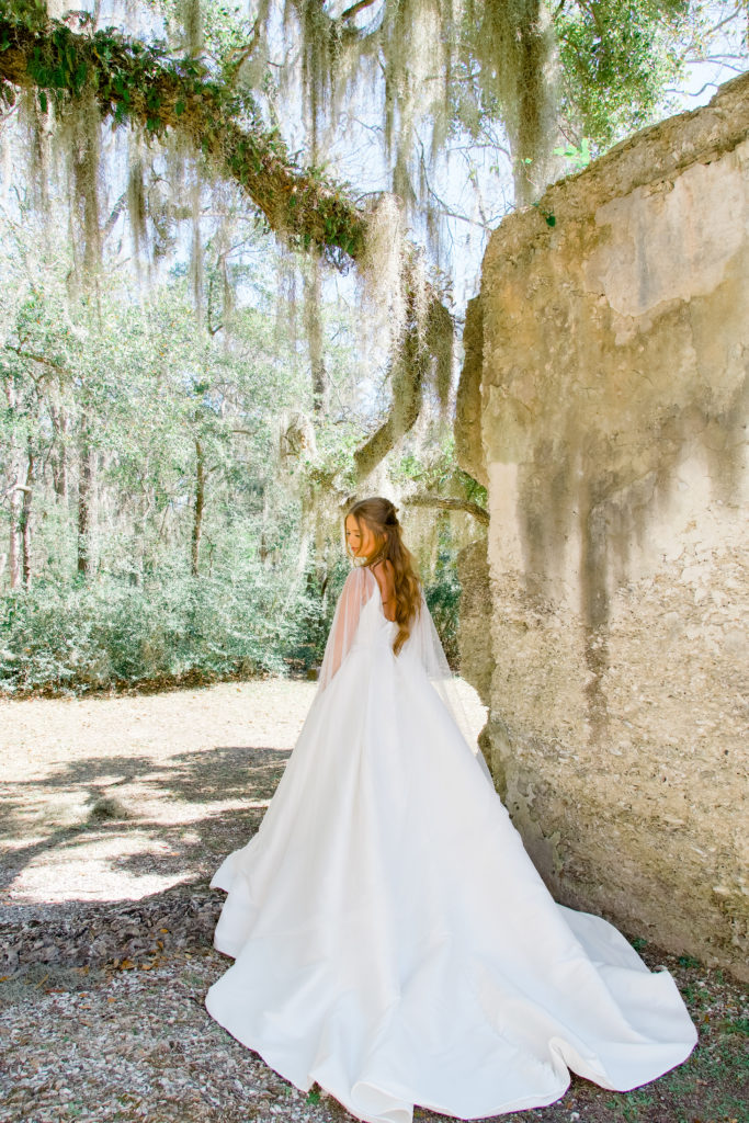 back of classic wedding dress with tulle cape