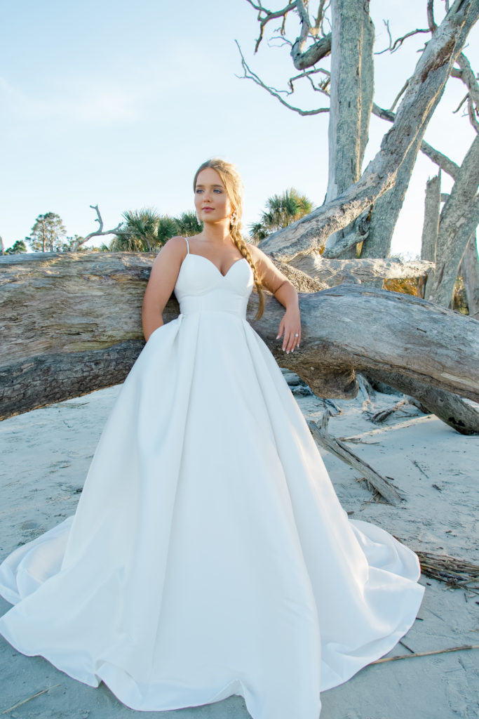 Classic ballgown wedding dress on driftwood beach